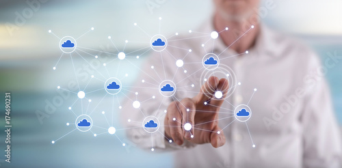 Man touching a cloud networking on a touch screen
