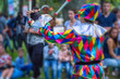 Back view streert juggler in bright clothing Back view streert juggler in bright clothing