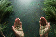 Backdrop for representing Christmas gift. Top view holiday sparkled open palms of woman on black festive background with pine. Happy celebration, greeting and congratulation concept Backdrop for representing Christmas gift. Top view holiday sparkled open palms of woman on black festive background with pine. Happy celebration, greeting and congratulation concept