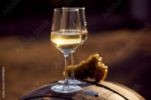 Two glasses of white wine with food at sunset