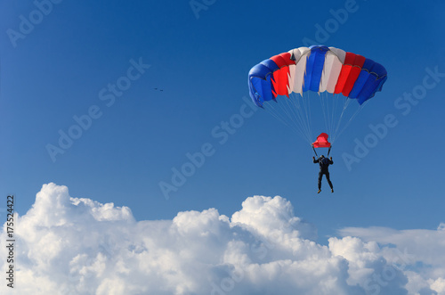 skydiver soars in the sky high above the clouds