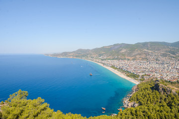 View from the mountain to the sea bay with blue water and ships