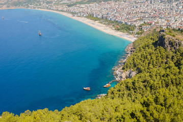 View from the mountain to the sea bay with blue water and ships