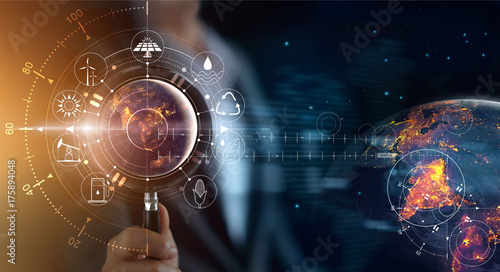Man holding magnifying glass, searching  world's consumption with icons energy sources  renewable, sustainable, Ecology concept. Elements of this image furnished by NASA.