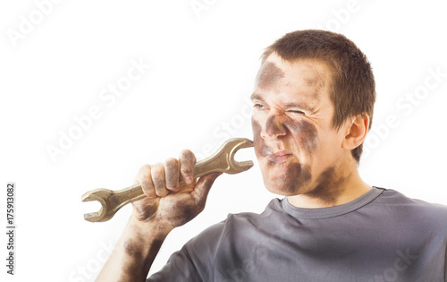 dirty and funny mechanic with wrench thinking