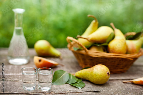 Pear brandy in shot glass.Pears in background.
