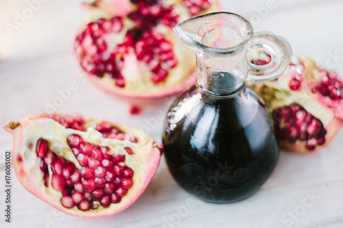 Glass jar with the pomegranate sauce inside it.
