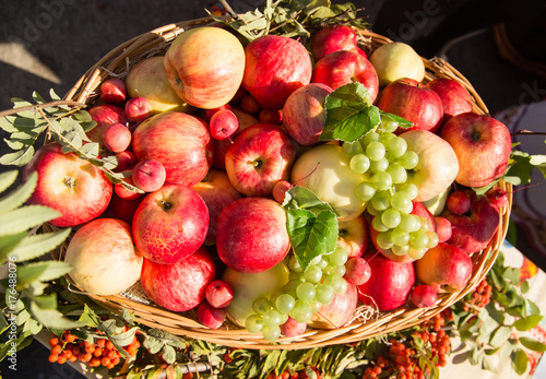 ripe apples with grapes in a basket