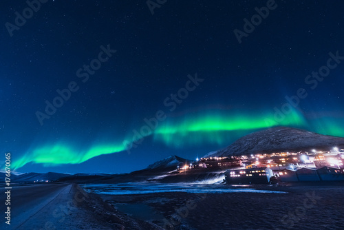 The polar arctic Northern lights aurora borealis sky star in Norway Svalbard in Longyearbyen the moon mountains