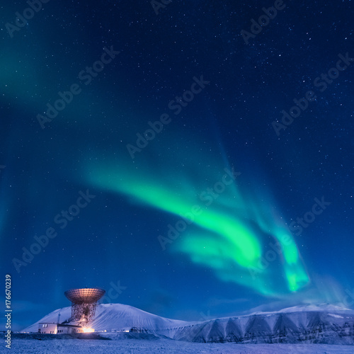 The polar arctic Northern lights aurora borealis sky star in Norway Svalbard in Longyearbyen the moon mountains