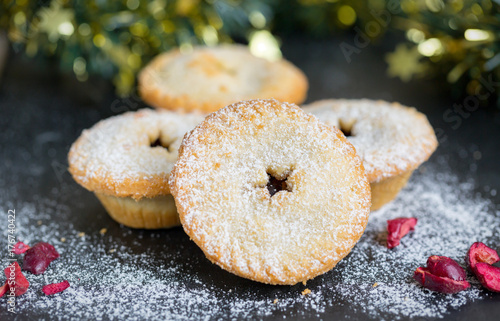 Mince pies on a slate plate with christmas decoration
