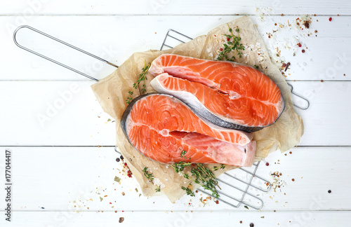 Salmon steak on white wooden table, top view