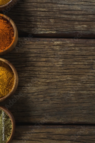 Various spice powder on wooden table