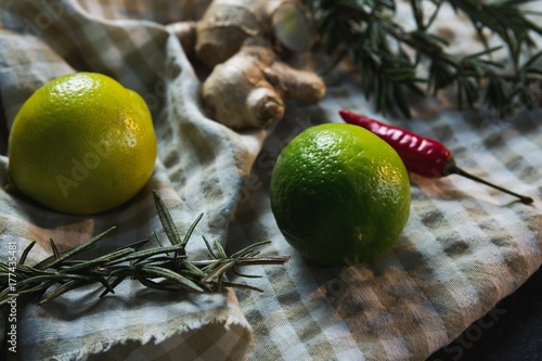 Sweet limes with rosemary and spices on table cloth