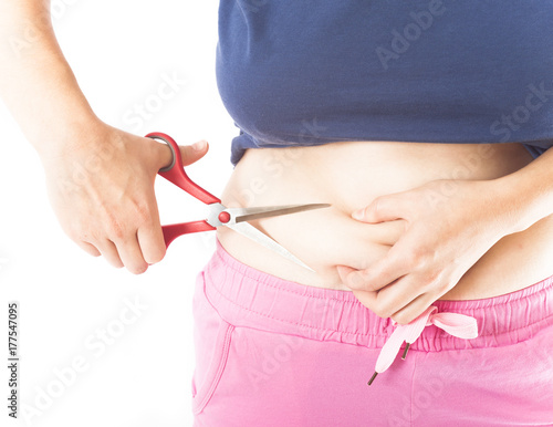 cutting belly fat with scissors, concept for losing weight