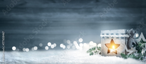 Christmas wood background with lantern, fir branches and lights