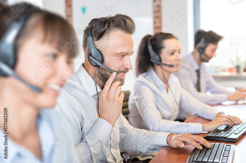 Call center worker accompanied by his team.