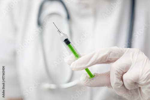 Syringe, medical injection in hand. Vaccination equipment.