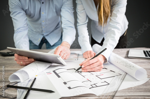 Designers discuss the sketches inside the house.