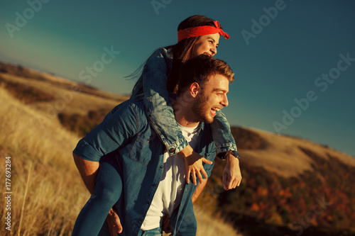 Happy young couple enjoys a sunny day in nature