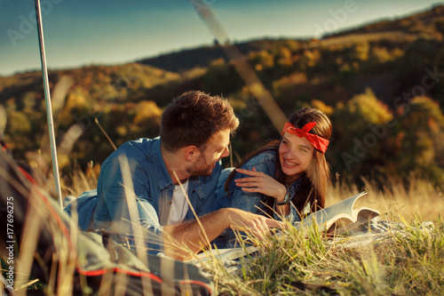 Young couple reads a book in nature