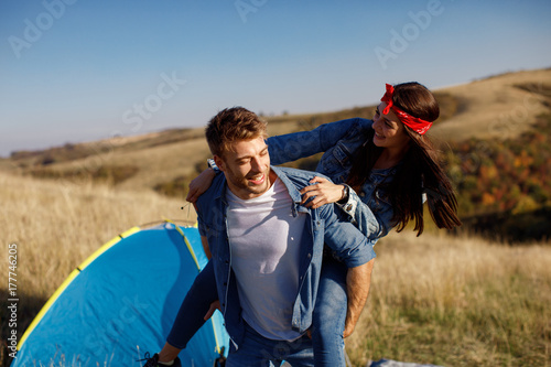 Happy young couple enjoys a sunny day in nature