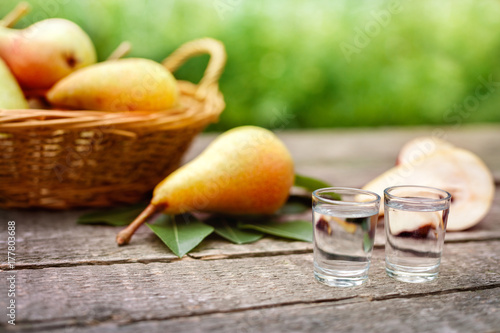 Pear brandy in shot glass with pear