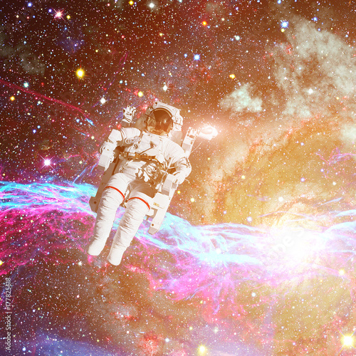 Astronaut in outer space. Nebula on the background.
