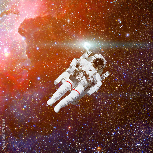 Astronaut in outer space. Nebula and stars on the background.