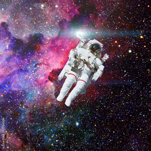 Astronaut in outer space. Nebula on the background.