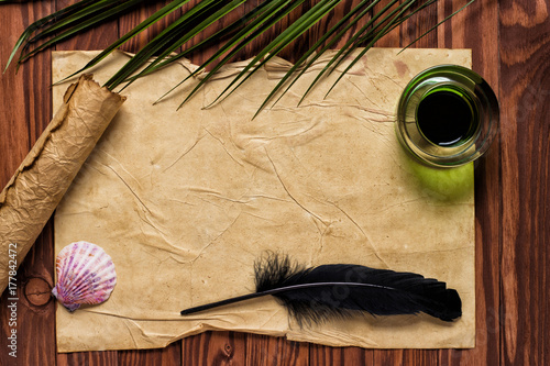 black quill pen and ink on old paper background