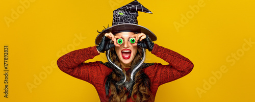 happy modern woman on yellow background having fun time