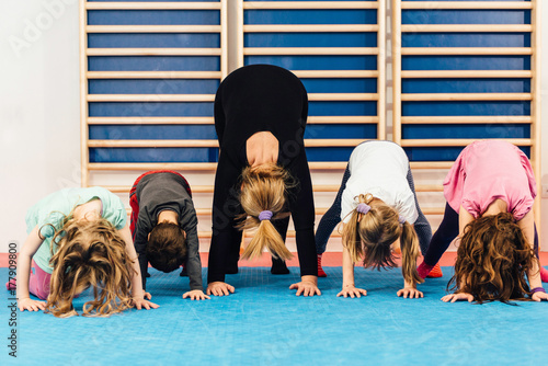Physical education - Teacher with children exercising