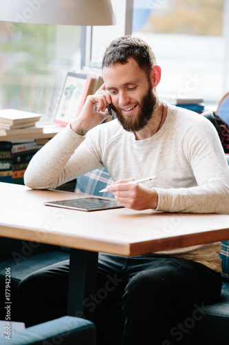 Man using tablet pc with a pencil at a desk
