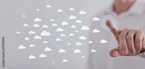 Man touching a cloud network on a touch screen
