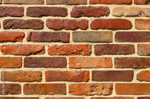 the wall is composed of bricks painted brown and orange paint