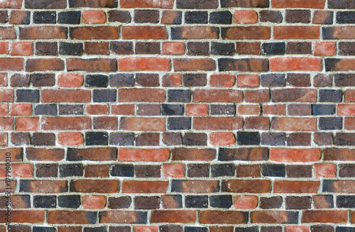 part of old brick wall consisting of bricks of different shades