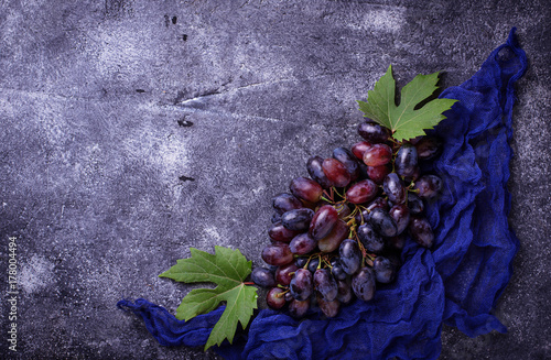 Bunch of purple grapes on concrete background