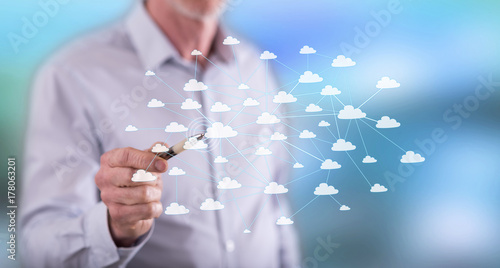 Man touching a cloud network on a touch screen