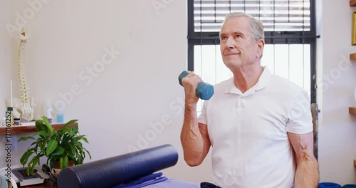 Senior man exercising with dumbbells 