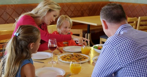 Family interacting with each other while having food 