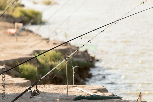 fishing rods on the river bank in nature