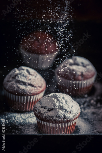 Delicious and homemade chocolate muffin on an old baking tray
