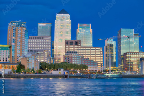 Canary Wharf buildings at night with river reflections