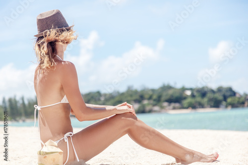 Beautiful fit body girl on travel vacation. Sexy bikini body woman playful on paradise tropical beach