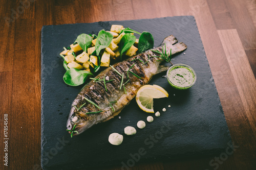 Grilled trout with potato and spinach