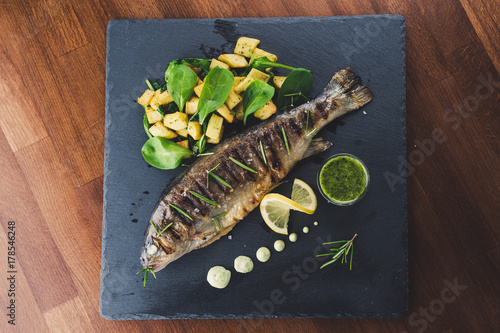 Grilled trout with potato and spinach