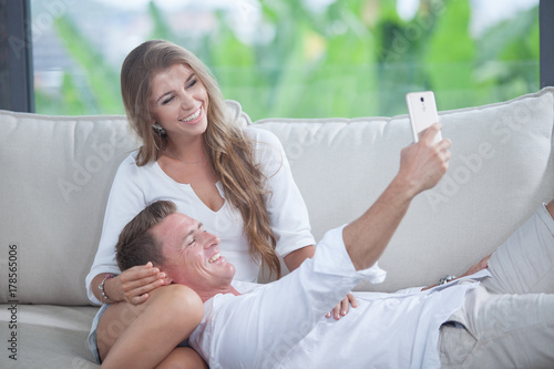 portrait of young couple  making self photo with mobile phone