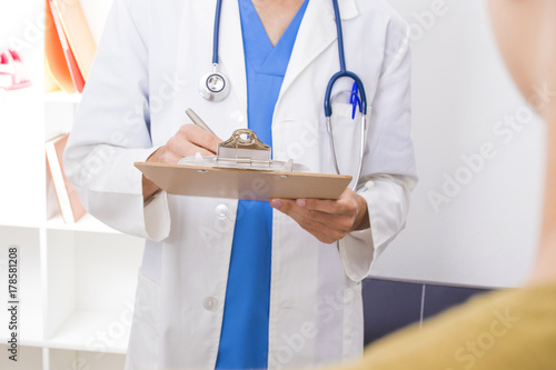 doctor writing the treatment or medical report