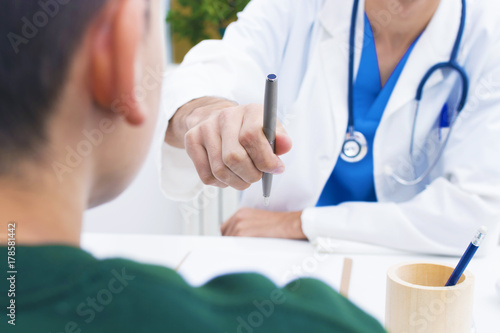doctor with pen to sign the contract
